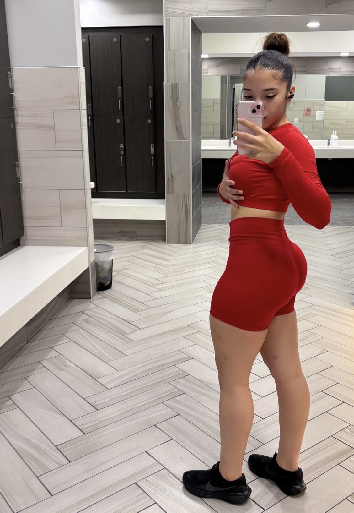 Red workout set - side profile showing fitness progress